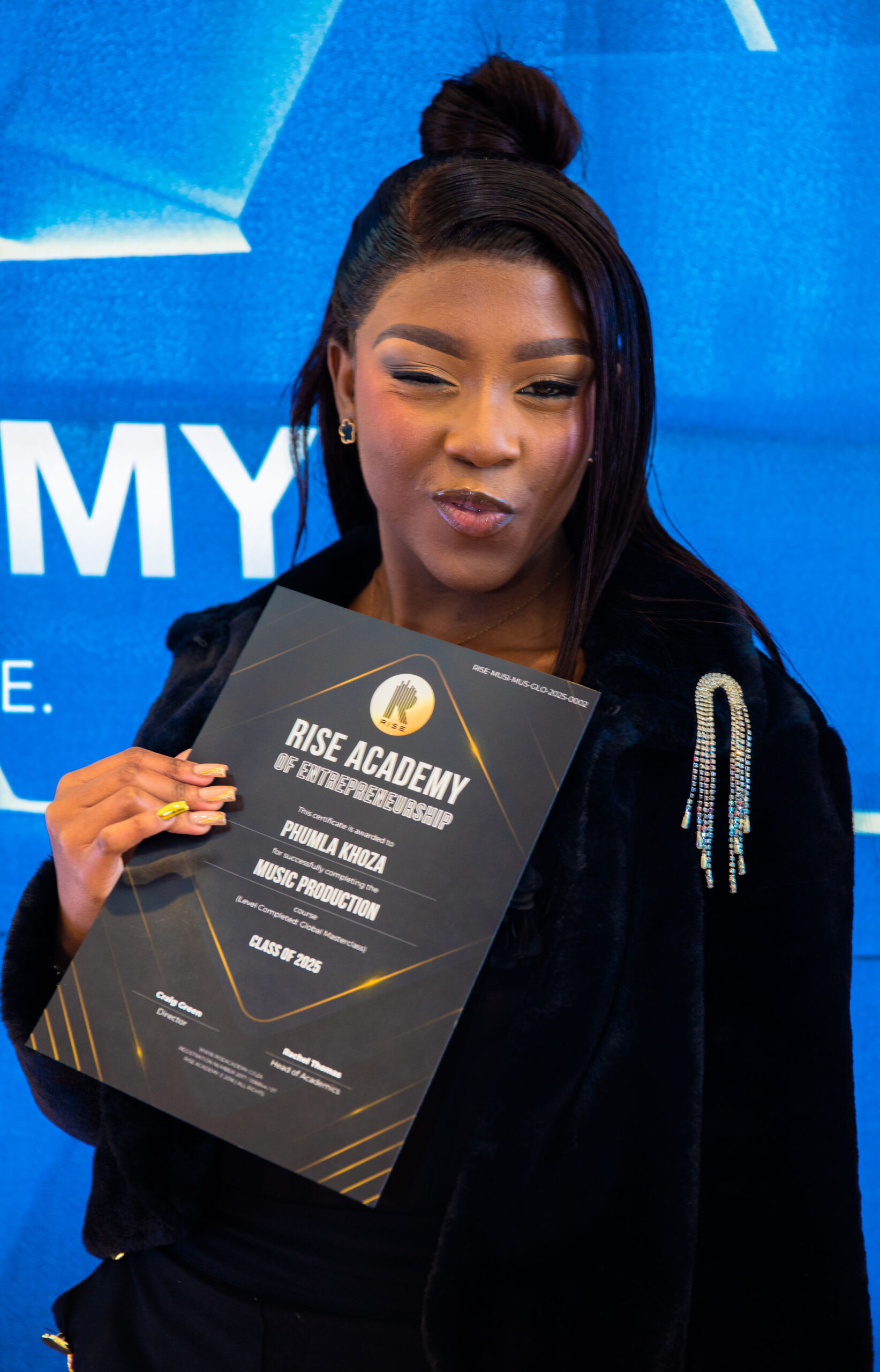 RISE Academy student with certificate